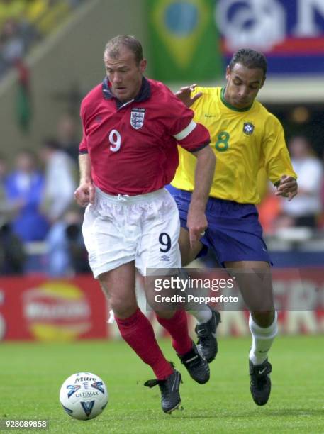 Alan Shearer of England is shadowed by Emerson of Brazil during an international friendly between England and Brazil at Wembley Stadium in London on...