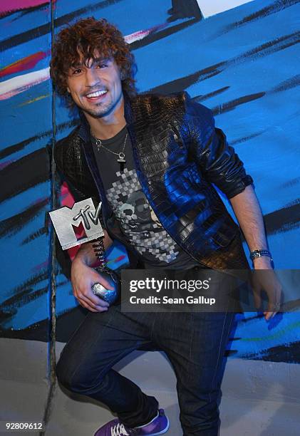 Russia MTV European Music Awards regional winner Dima Bilan poses with his award at a photocall at the MTV European Music Awards in front of the...