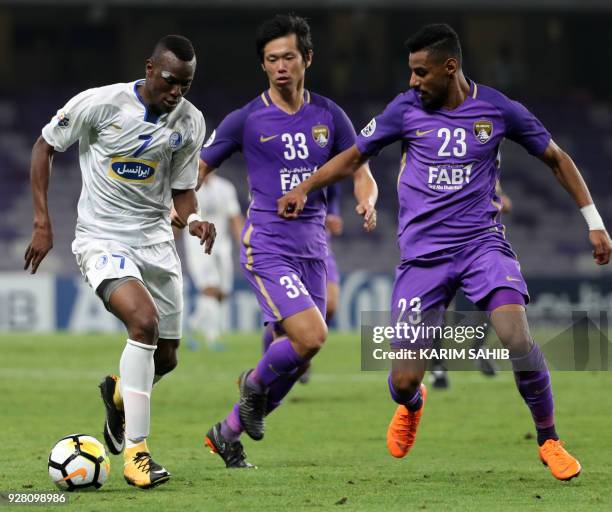 Al-Ain FC's Japanese defender Tsukasa Shiotani and Emirati defender Mohamed Ahmed vie for the ball against Esteghlal FC's Senegalese midfielder Mame...