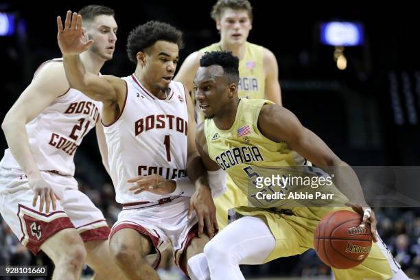 Josh Okogie of the Georgia Tech Yellow Jackets works against Jerome Robinson of the Boston College Eagles in the first half during the first round of...