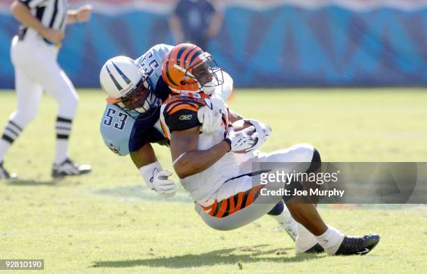 Titans' Keith Bulluck tackles Chris Perry during first half action between the Cincinnati Bengals and the Tennessee Titans at The Coliseum in...
