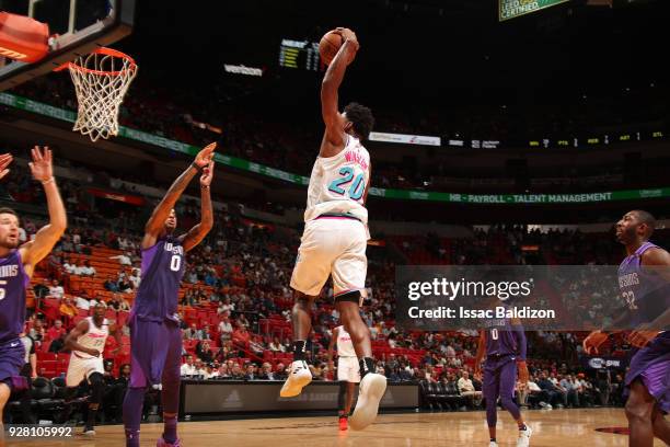 Justise Winslow of the Miami Heat dunks the ball while guarded by Marquese Chriss of the Phoenix Suns on March 5, 2018 at American Airlines Arena in...