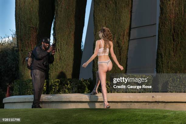 Woman wearing revealing lingerie poses for photographers along The Strip in front of Caesars Palace on March 2, 2018 in Las Vegas, Nevada. Millions...