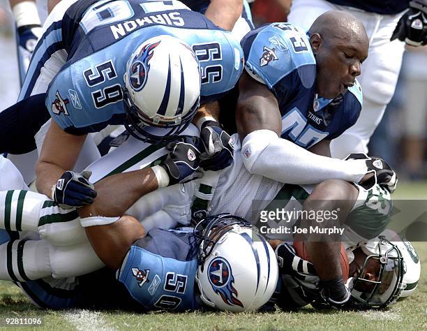 The Jets Derrick Blaylock is tackled by Titans Keith Bulluck, Peter Sirmon and David Thornton at The Coliseum, Nahsville, Tennessee, September 10,...