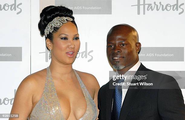 Designer Kimora Lee Simmons and actor Djimon Hounsou attend The Emerald Ball in aid of The Elton John AIDS Foundation at Harrods on November 5, 2009...