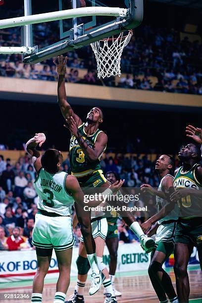 Gary Payton of the Seattle SuperSonics shoots a layup against Dennis Johnson of the Boston Celtics during a game played in 1989 at the Boston Garden...