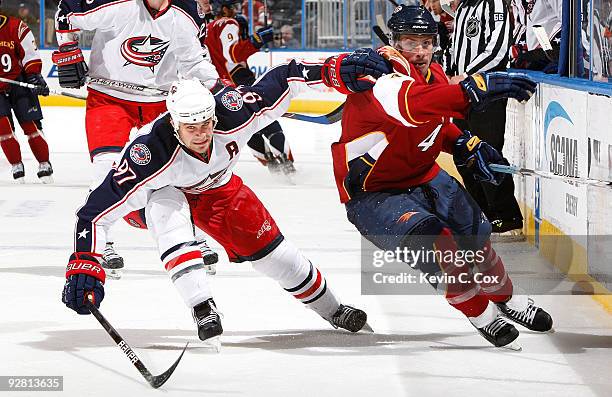 Rostislav Klesla of the Columbus Blue Jackets battles for the puck against Zach Bogosian of the Atlanta Thrashers at Philips Arena on November 5,...