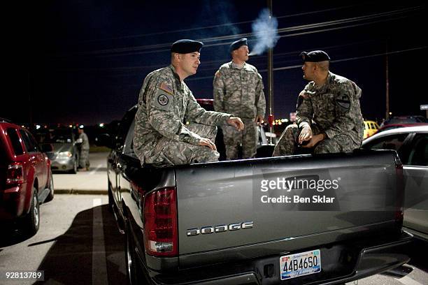 Spc. Chad Rings, Spc. David Straub, and Spc. Ryan Howard wait to enter Ft. Hood near the main entrance to the base on November 5, 2009 in Killeen,...