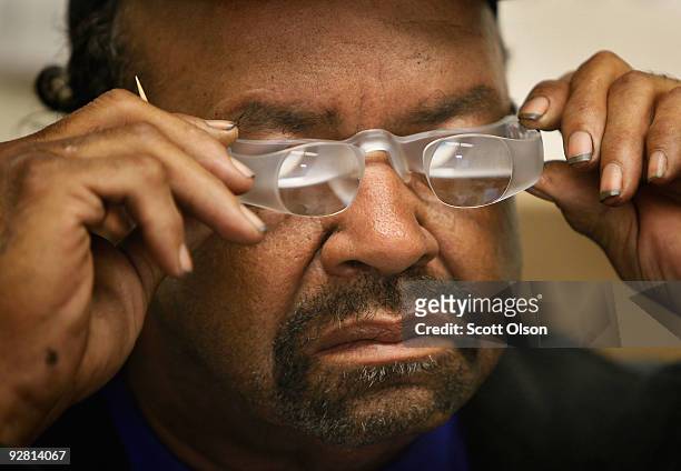 Milton McFarland of Maywood, tries out a pair of Maxtv glasses at the Central Blind Rehabilitation Center at the Edward Hines Jr. VA Hospital...