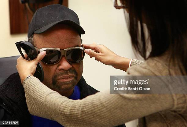 Milton McFarland of Maywood, Illinois is fitted for sunglasses by optometry student Daman Gupta at the Central Blind Rehabilitation Center at the...