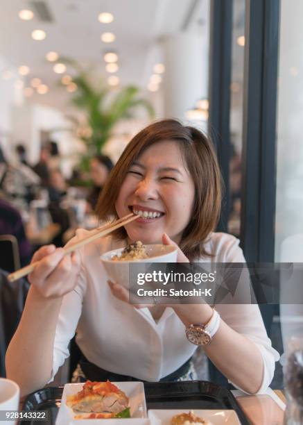 young woman full of smile at lunch - japanese chopsticks stock pictures, royalty-free photos & images