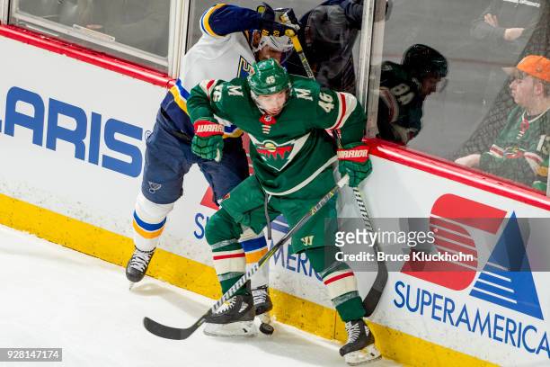 Alexander Steen of the St. Louis Blues and Jared Spurgeon of the Minnesota Wild battle for the puck along the boards during the game at the Xcel...