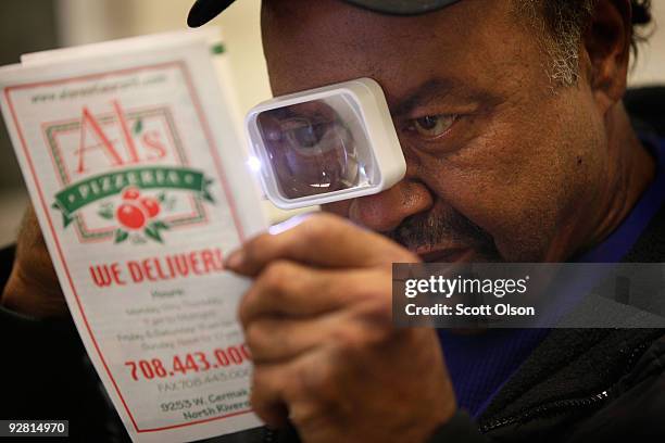 Milton McFarland of Maywood, learns to read using a pocket magnifier at the Central Blind Rehabilitation Center at the Edward Hines Jr. VA Hospital...