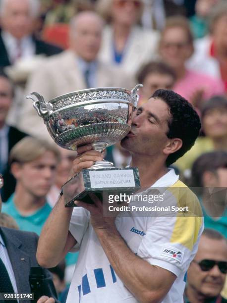 Andres Gomez of Ecuador kissing the trophy after defeating Andre Agassi of the USA in the Men's Singles Final of the French Open Tennis Championships...