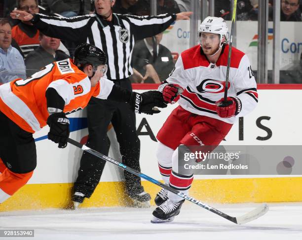 Ivan Provorov of the Philadelphia Flyers skates against Elias Lindholm of the Carolina Hurricanes on March 1, 2018 at the Wells Fargo Center in...