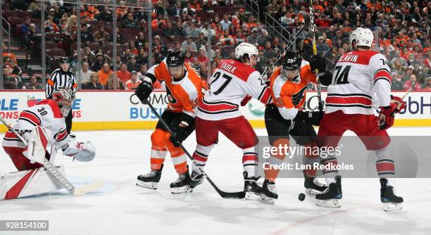 Michael Raffl and Taylor Leier of the Philadelphia Flyers battle on a scoring opportunity against Cam Ward, Justin Faulk and Jaccob Slavin of the...