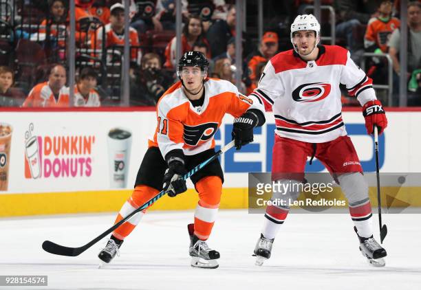Travis Konecny of the Philadelphia Flyers skates against Trevor van Riemsdyk of the Carolina Hurricanes on March 1, 2018 at the Wells Fargo Center in...