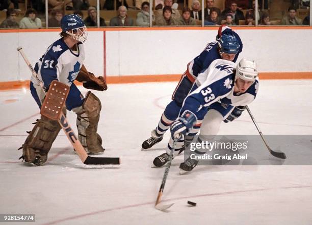 Al Iafrate and Ken Wregget of the Toronto Maple Leafs skate against Pat Flatley of the New York Islanders during NHL game action on March 20, 1986 at...