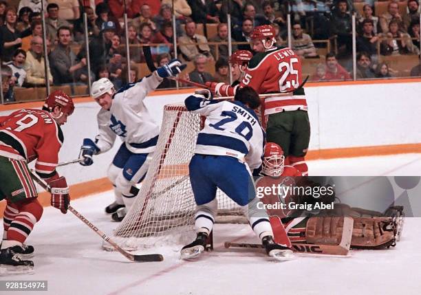 Brad Smith and Wendel Clark of the Toronto Maple Leafs skate against Rich Preston, Dave Lewis and Alain Chevrier of the New Jersey Devils during NHL...