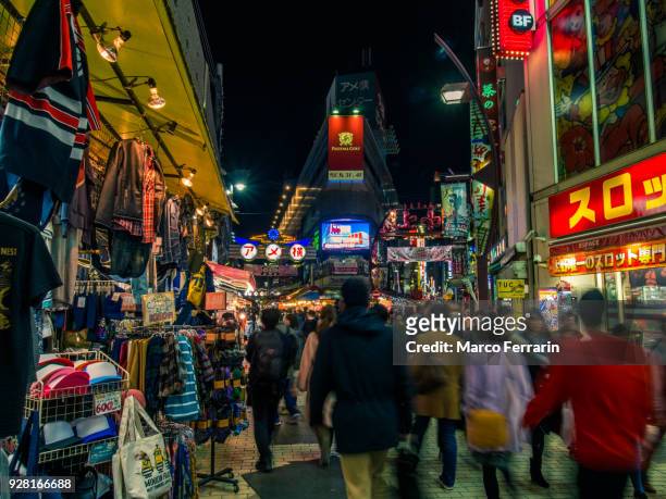 japanese city life at night, blurred motion of people walking along crowded shopping alley, ameya-yokocho - ameya yokocho fotografías e imágenes de stock