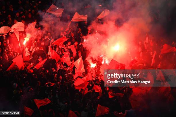 Fans light flares prior to the UEFA Champions League Round of 16 Second Leg match between Paris Saint-Germain and Real Madrid at Parc des Princes on...