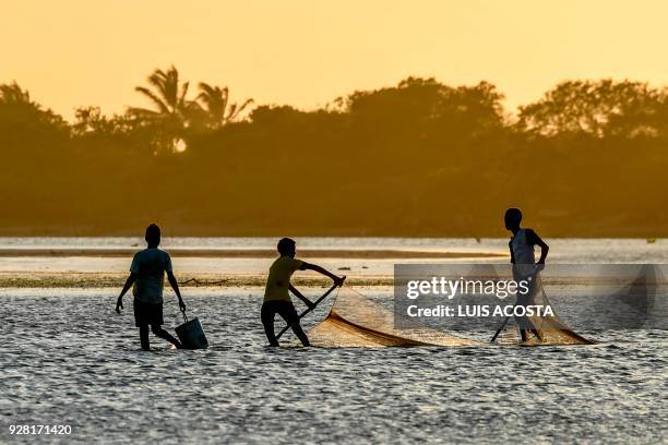 Fishermen fish shrimps at the Navio Quebrado lagoon in the village of Boca de Camarones, Guajira Department, northern Colombia, on March 1 2018....