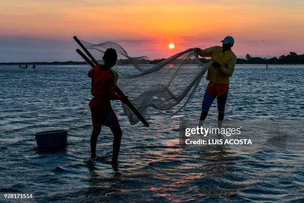 Fishermen fish shrimps at the Navio Quebrado lagoon in the village of Boca de Camarones, Guajira Department, northern Colombia, on March 1 2018....