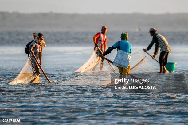 Fishermen fish shrimps at the Navio Quebrado lagoon in the village of Boca de Camarones, Guajira Department, northern Colombia, on March 1 2018....