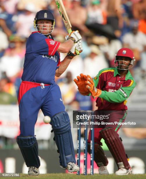 Andrew Flintoff batting England watched by West Indies wicketkeeper Denesh Ramdin during the ICC World Cup Super Eight match between West Indies and...