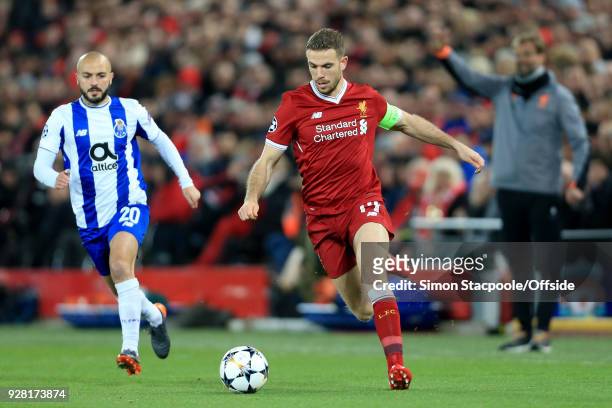 Jordan Henderson of Liverpool in action with Andre Andre of FC Porto during the UEFA Champions League Round of 16 Second Leg match between Liverpool...