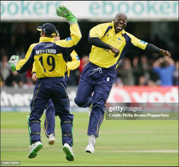 Ottis Gibson of Durham celebrates after taking the second of two wickets with the first two balls of the Hampshire innings with teammate Phil Mustard...