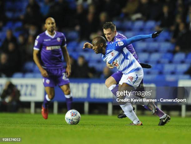 Bolton Wanderers' Andrew Taylor vies for possession with Reading's Sone Aluko during the Sky Bet Championship match between Reading and Bolton...