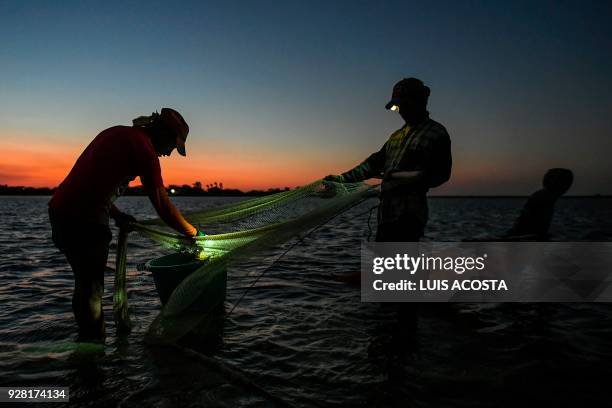 Fishermen fish shrimps at the Navio Quebrado lagoon in the village of Boca de Camarones, Guajira Department, northern Colombia, on March 1 2018....