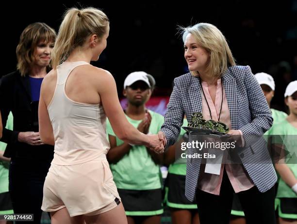 Felicity Barnard, CEO of Tie Break Tens presents winner Elina Svitolina of the Ukraine with the trophy during the Tie Break Tens at Madison Square...