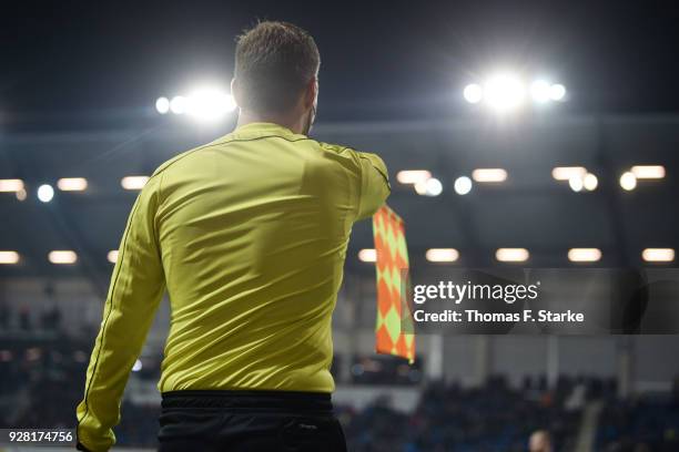Referee assistant raises his flag during the 3. Liga match between SC Paderborn 07 and 1. FC Magdeburg at on March 6, 2018 in Paderborn, Germany.