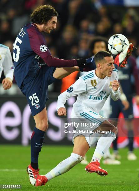 Lucas Vazquez of Real Madrid is challenged by Adrien Rabiot of PSG during the UEFA Champions League Round of 16 Second Leg match between Paris...