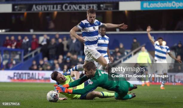 Derby County's David Nugent and Queens Park Rangers goalkeeper Alex Smithies battle for the ball during the Sky Bet Championship match at Loftus...