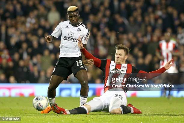 Lee Evans of Sheffield United slide tackles Sheyi Ojo of Fulham during the Sky Bet Championship match between Fulham and Sheffield United at Craven...