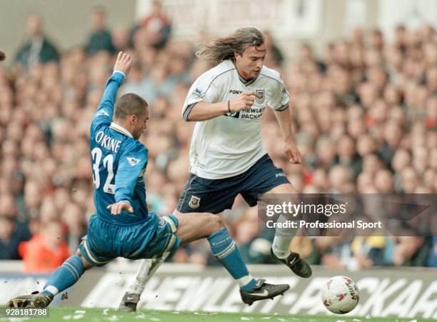 David Ginola of Tottenham Hotspur skips past John O'Kane of Everton during an FA Carling Premiership match at White Hart Lane on April 4, 1998 in...