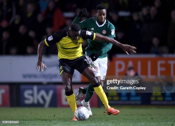 Lucas Akins of Burton Albion is challenged by Florian Jozefzoon of Brentford during the Sky Bet Championship match between Burton Albion and...