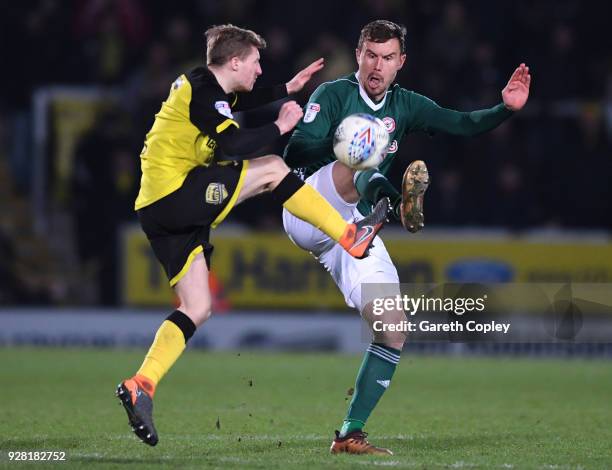 Andreas Bjelland of Brentford is challenged by Jamie Allen of Burton Albion during the Sky Bet Championship match between Burton Albion and Brentford...