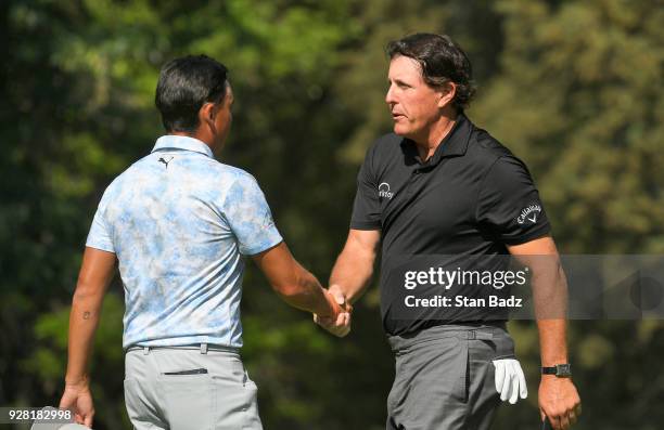 Rickie Fowler and Phil Mickelson shake hands on the 18th hole during round three of the World Golf Championships-Mexico Championship at Club de Golf...