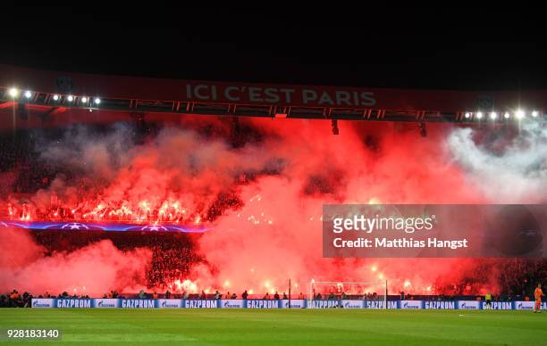 Fans light flares during the UEFA Champions League Round of 16 Second Leg match between Paris Saint-Germain and Real Madrid at Parc des Princes on...