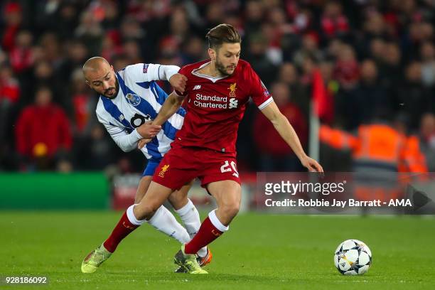 Andre Andre of FC Porto and Adam Lallana of Liverpool during the UEFA Champions League Round of 16 Second Leg match between Liverpool and FC Porto at...
