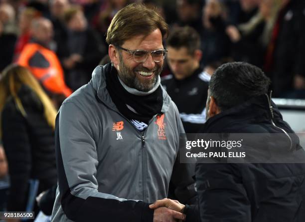 Liverpool's German manager Jurgen Klopp greets Porto's Portuguese coach Sergio Conceicao before the UEFA Champions League round of sixteen second leg...