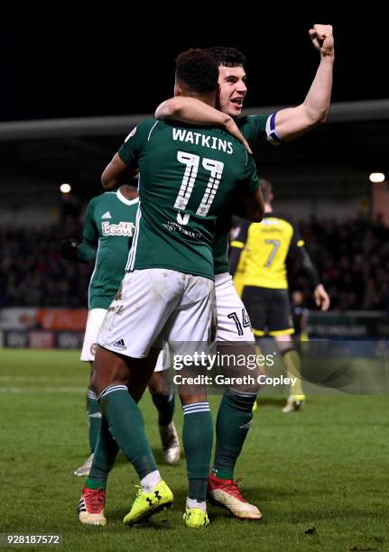 Andreas Bjelland of Brentford celebrates his sides first goal with Ollie Watkins of Brentford as Kyle McFadzean of Burton Albion scored a own goal...