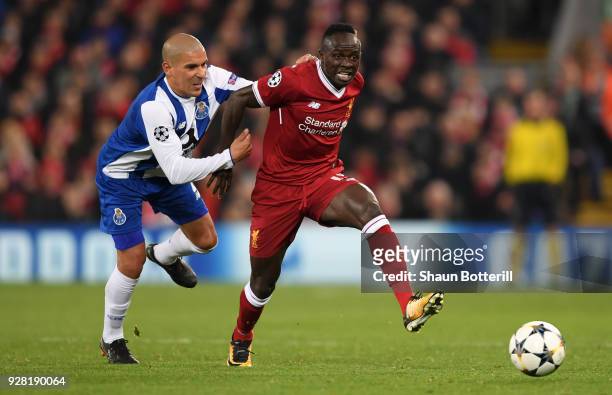 Sadio Mane of Liverpool is challenged by Maximiliano of FC Porto during the UEFA Champions League Round of 16 Second Leg match between Liverpool and...