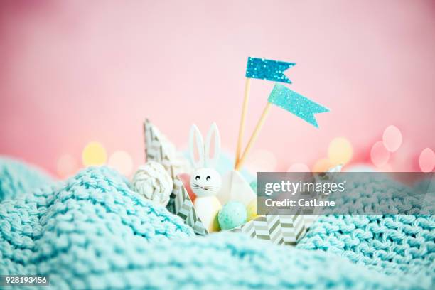 handmade origami boat filled with tiny easter eggs and easter bunny - easter fantasy stock pictures, royalty-free photos & images