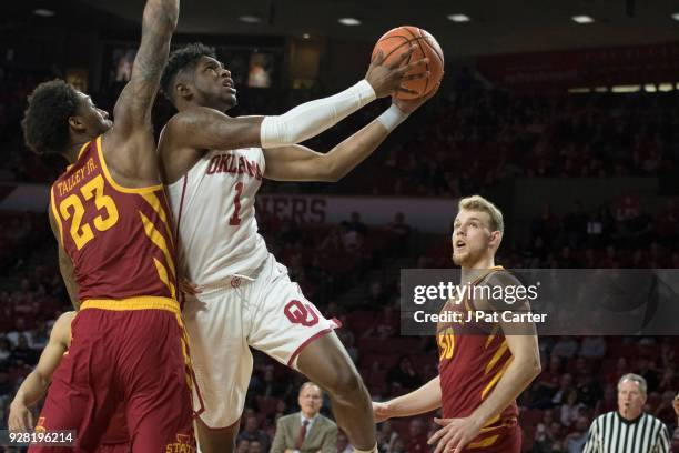 Rashard Odomes of the Oklahoma Sooners shoots over Solomon Young of the Iowa State Cyclones during the second half of a NCAA college basketball game...