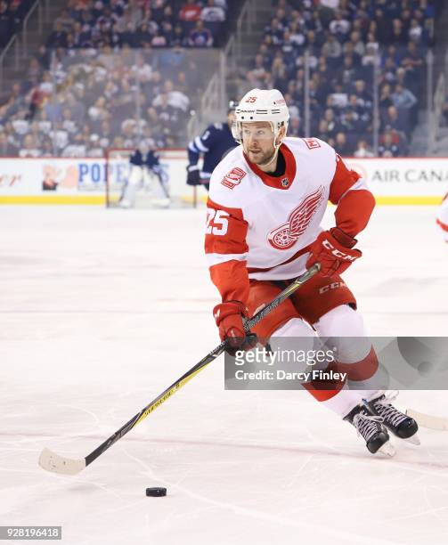 Mike Green of the Detroit Red Wings plays the puck down the ice during first period action against the Winnipeg Jets at the Bell MTS Place on March...